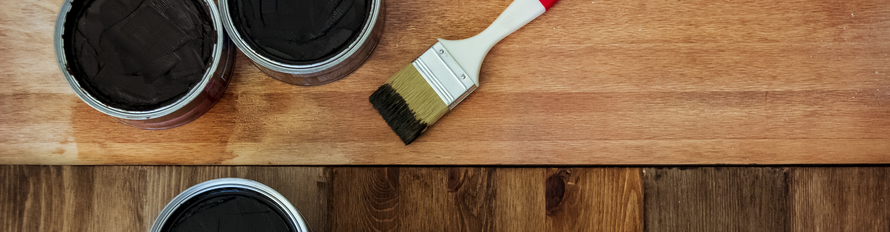 Closeup of hardwood floors with brush and stain 